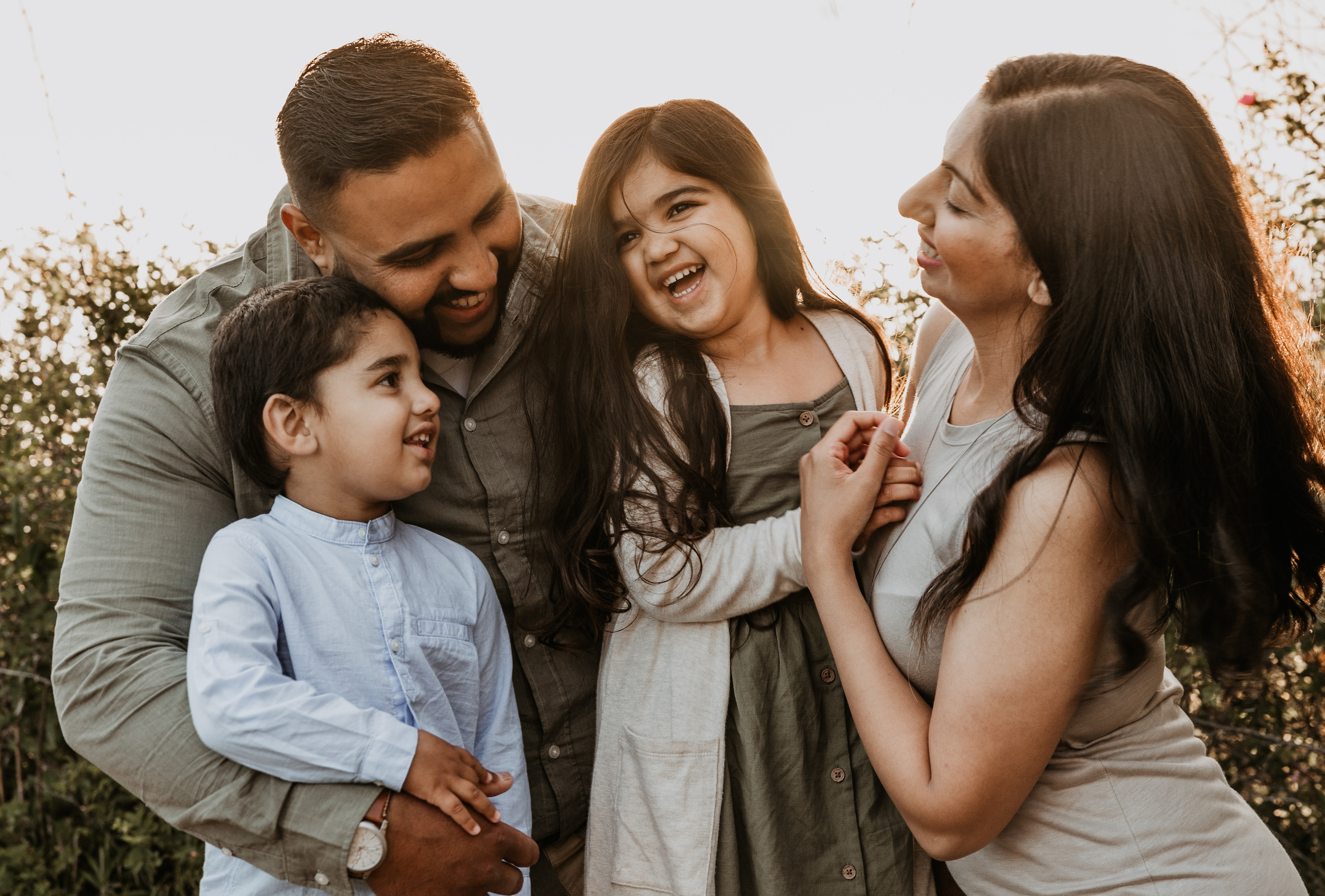 Family laughing together in golden light, San Antonio